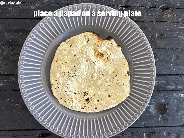Step 13 – Place a papad on a serving plate.