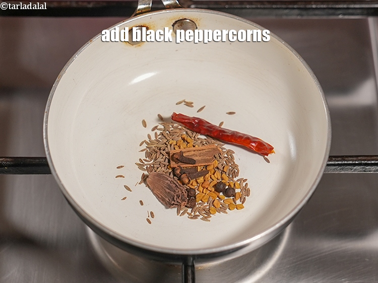 Step 9 – Add 4 <a href="https://www.tarladalal.com/glossary-black-peppercorns-kali-mirch-kalimirch-566i">black peppercorns (kalimirch)</a>.