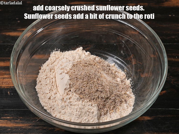 Step 9 – Add 2 tbsp coarsely crushed <a href="https://www.tarladalal.com/glossary-sunflower-seeds-surajmukhi-ke-beej-611i">sunflower seeds (surajmukhi ke beej)</a>. Sunflower seeds add a …