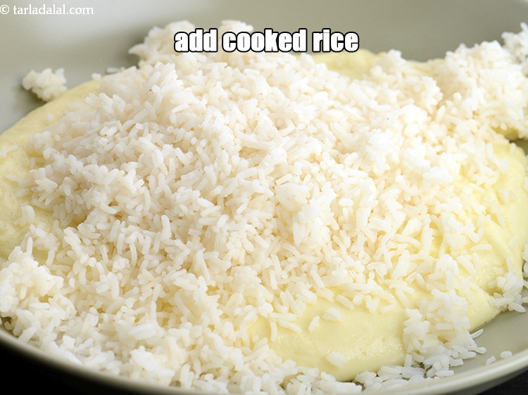 Step 9 – Add 1 &frac12; cups <a href="https://www.tarladalal.com/cooked-rice-chawal-4800r">cooked rice (chawal)</a>.