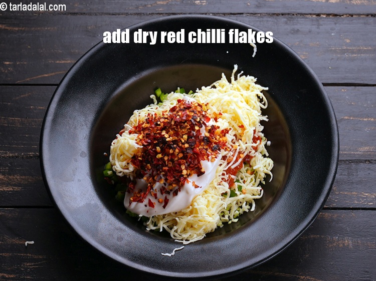 Step 9 – Add 2 tsp&nbsp;<a href="https://www.tarladalal.com/glossary-dry-red-chilli-flakes-paprika-338i">dry red chilli flakes (paprika)</a>.