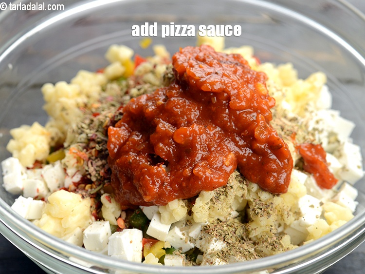 Step 9 – Add 2 tbsp <a href="https://www.tarladalal.com/glossary-pizza-sauce-1889i">pizza sauce</a>.