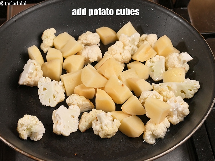 Step 9 – Add 1 cup <a href="https://www.tarladalal.com/glossary-potato-cubes-725i">potato cubes</a>.