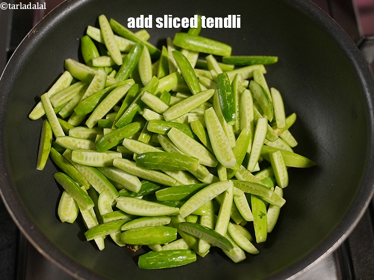 Step 9 – Add 3 cups&nbsp;<a href="https://www.tarladalal.com/glossary-sliced-tendli-1161i">sliced tendli</a>.