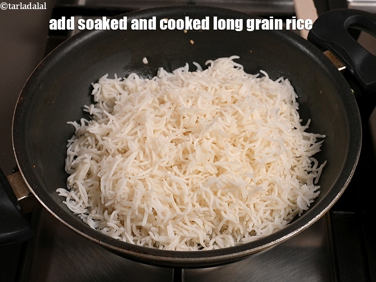 Step 9 – Add 2&frac12; cups <a href="https://www.tarladalal.com/glossary-soaked-and-cooked-long-grain-rice--1904i">soaked and cooked long grain rice (basmati chawal)</a>.