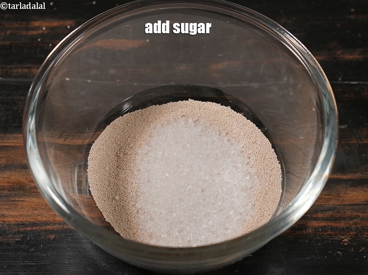 Step 8 – Add the castor sugar. Sugar has multiple roles in bread making. One being it acts …