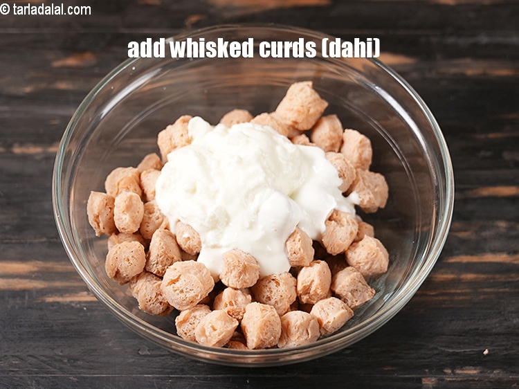 Step 9 – Add &frac12; cup <a href="https://www.tarladalal.com/glossary-whisked-curds--2096i">whisked curds (dahi)</a>.