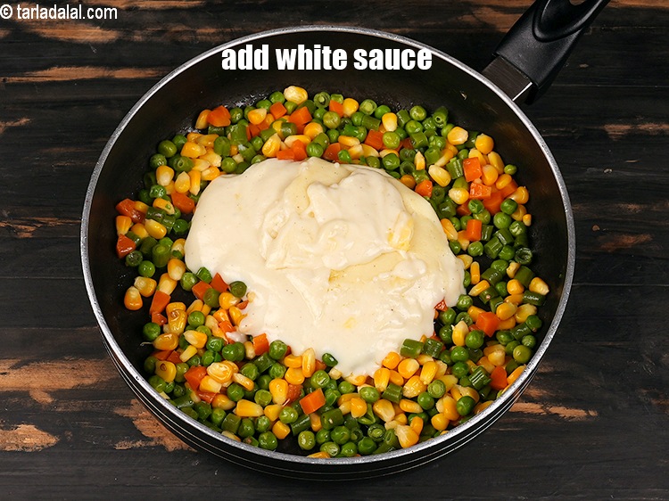 Step 9 – Add 1 cup&nbsp;<a href="https://www.tarladalal.com/white-sauce-113r">white sauce</a>.&nbsp;