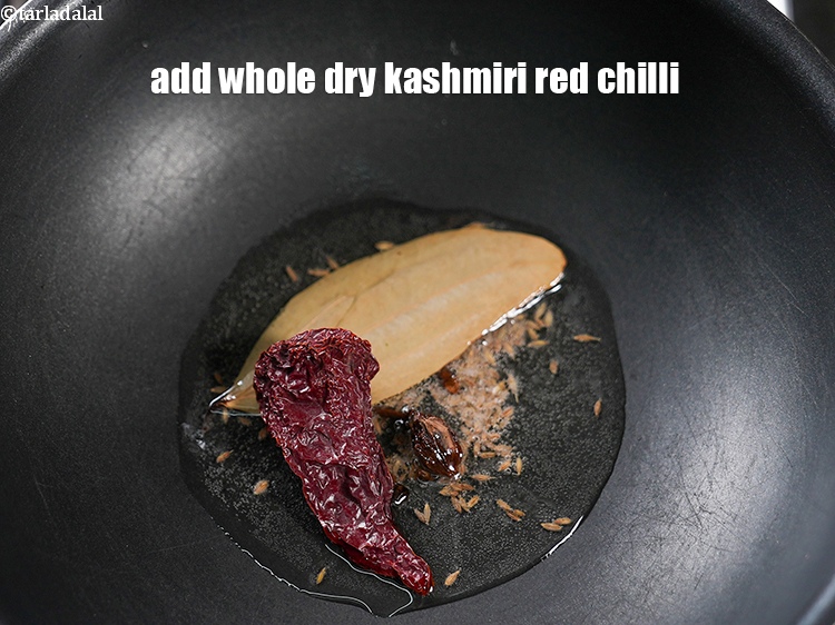 Step 9 – Add 1 <a href="https://www.tarladalal.com/glossary-whole-dry-kashmiri-red-chillies-kashmiri-mirch-kashmiri-lal-mirch-332i">whole dry kashmiri red chilli</a>.&nbsp;