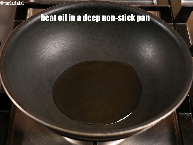 Step 9 – Heat &frac14; cup oil in a deep non-stick pan.