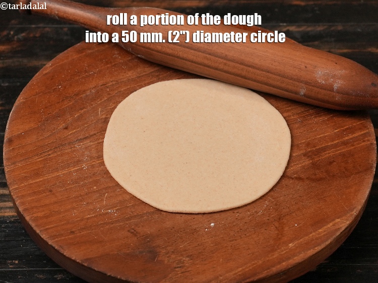 Step 12 – Roll a portion of the dough into a 50 mm. (2&quot;) diameter circle.