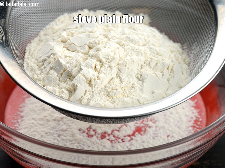 Step 13 – Sieve 1 cup <a href="https://www.tarladalal.com/glossary-plain-flour-maida-188i">plain flour (maida)</a>.