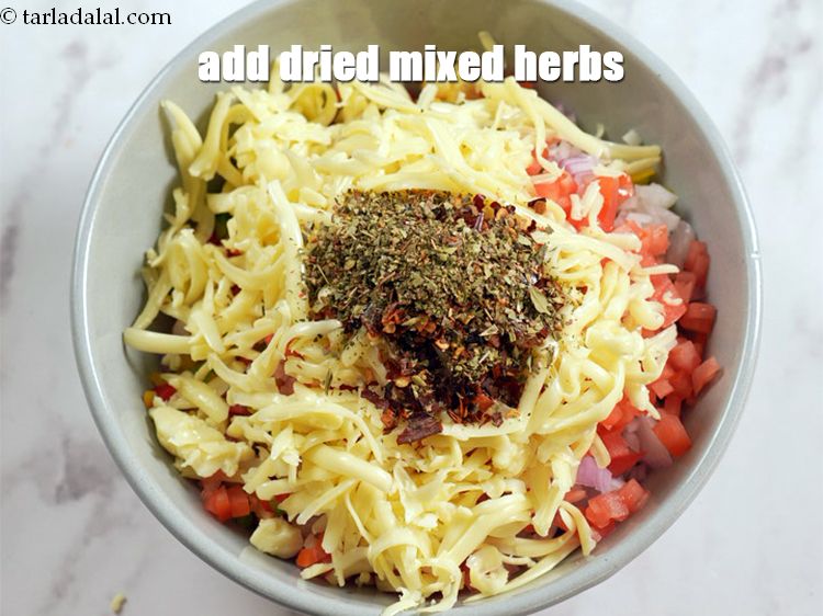 Step 10 – Add 1 tsp <a href="https://www.tarladalal.com/glossary-dried-mixed-herbs-466i">dried mixed herbs</a>.