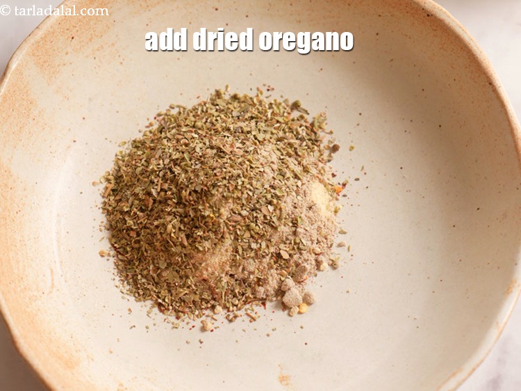 Step 9 – Add 4 tsp&nbsp;<a href="https://www.tarladalal.com/glossary-dried-oregano-268i">dried oregano</a>.