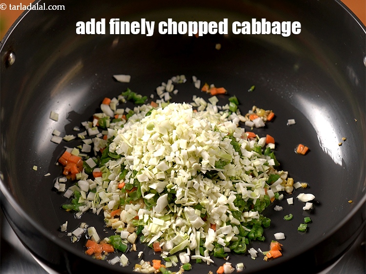 Step 13 – Add &frac14; cup finely <a href="https://www.tarladalal.com/glossary-chopped-cabbage-781i">chopped cabbage</a>.