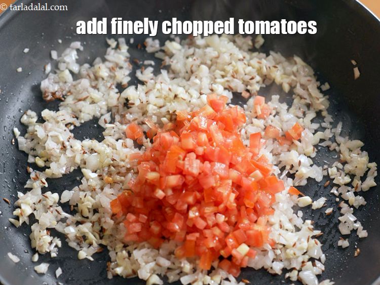Step 9 – Add &frac12; cup finely <a href="https://www.tarladalal.com/glossary-chopped-tomatoes-779i">chopped tomatoes</a>.