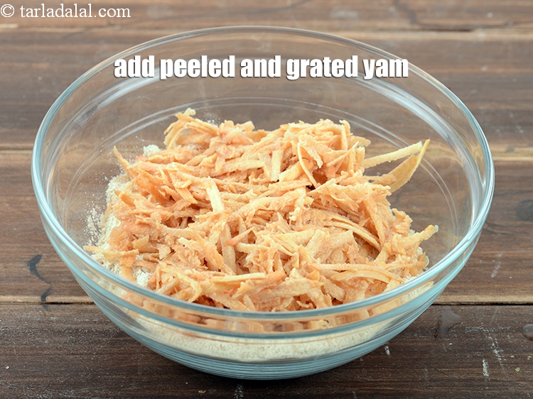 Step 9 – Add 1&frac12; cup peeled and <a href="https://www.tarladalal.com/glossary-grated-yam-2239i">grated yam</a>.
