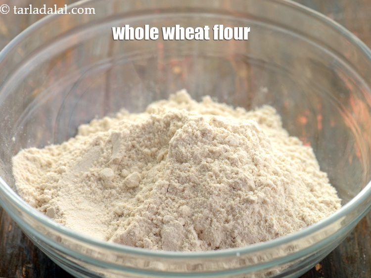 Step 7 – For preparing the dough for <strong>Homemade whole wheat bread rolls</strong>, in a deep bowl take …