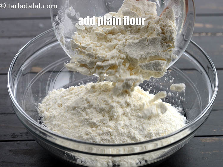 Step 9 – Add 1 cup <a href="https://www.tarladalal.com/glossary-plain-flour-maida-188i">plain flour (maida)</a>.