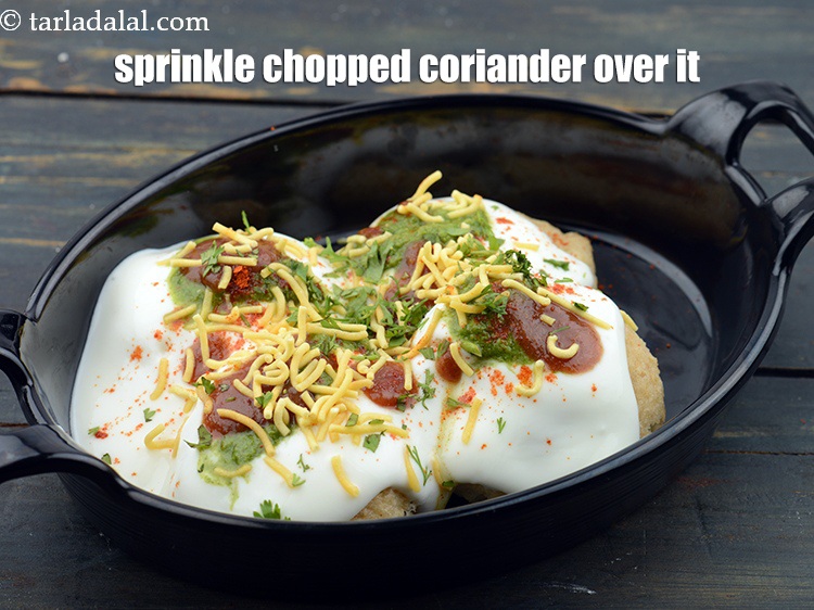 Step 69 – Sprinkle 1 tbsp <a href="https://www.tarladalal.com/glossary-chopped-coriander-783i">chopped coriander (dhania)</a>&nbsp;evenly over it.