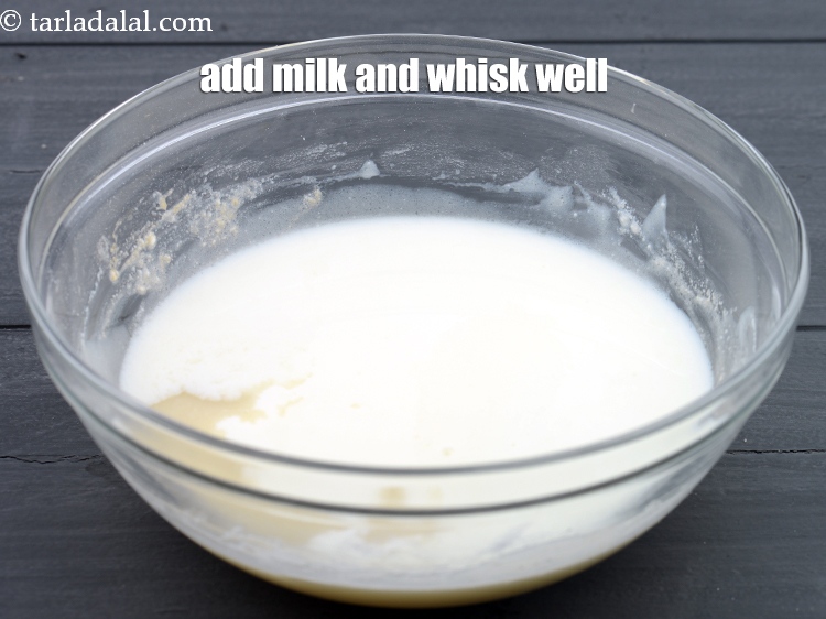 Step 9 – Add 1/2 cup&nbsp;<a href="https://www.tarladalal.com/glossary-milk-doodh-full-cream-milk-514i">milk</a>&nbsp;and whisk well.&nbsp;