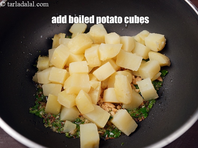 Step 10 – Add 1 cup <a href="https://www.tarladalal.com/glossary-boiled-potato-cubes-2312i">boiled potato cubes</a>.