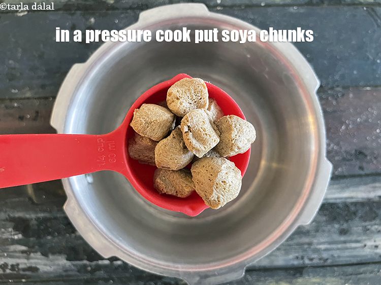 Step 9 – In a pressure cooker put&nbsp;<meta charset="UTF-8" />1/4 cup&nbsp;<a href="glossary-soy-chunks-soy-nuggets-soya-chunks-soya-nuggets-619i">soya chunks (nuggets)</a>.