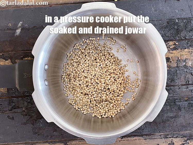 Step 9 – <meta charset="UTF-8" />In a pressure cooker put&nbsp;the soaked and drained jowar.&nbsp;