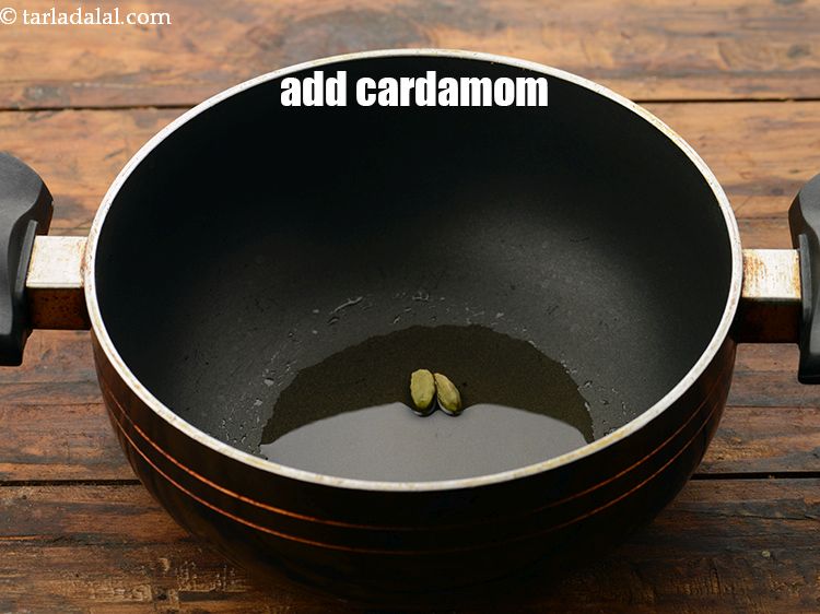 Step 8 – Add the spices first starting with 2&nbsp;<a href="https://www.tarladalal.com/glossary-cardamom-elaichi-262i">cardamoms (elaichi)</a>.&nbsp;