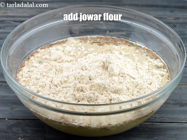 Step 9 – Add 1&frac14; cup&nbsp;<a href="https://www.tarladalal.com/glossary-jowar-flour-jowar-ka-atta-white-millet-flour-sorghum-flour-483i">jowar (white millet) flour</a>.
