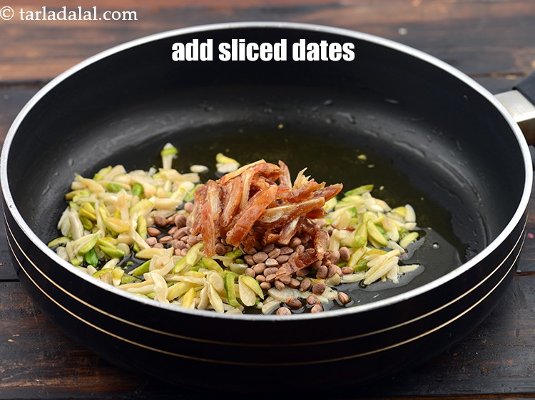 Step 9 – Add 2 tbsp&nbsp;<a href="https://www.tarladalal.com/glossary-sliced-dates-764i">sliced dates (khajur)</a>.