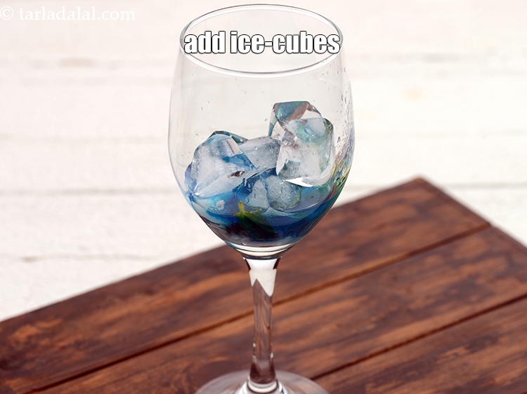 Step 9 – Add 6 <a href="https://www.tarladalal.com/glossary-ice-cubes-752i">ice-cubes</a>.