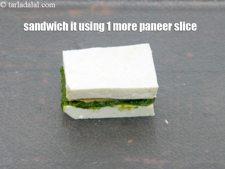 Step 20 – Sandwich it using 1 more paneer slice. Repeat to make 7 more cheese stuffed paneer. …