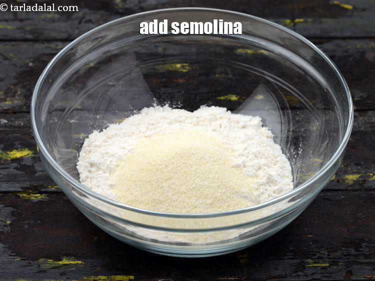 Step 11 – Add the <a href="https://www.tarladalal.com/glossary-semolina-sooji-rava-rawa-603i" target="_blank">semolina</a>.