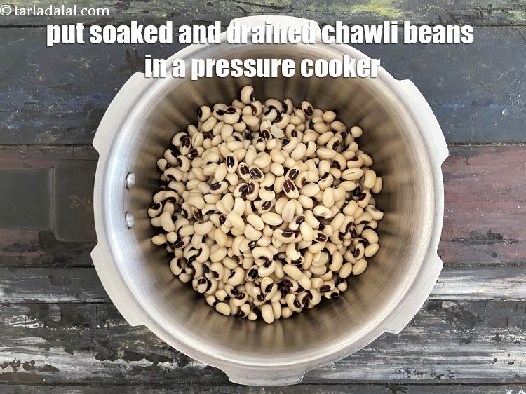 Step 9 – In a pressure cooker put &nbsp;<a href="glossary-soaked-chawli-1619i">soaked and drained chawli (cow pea / lobhia)</a>.&nbsp;&nbsp;