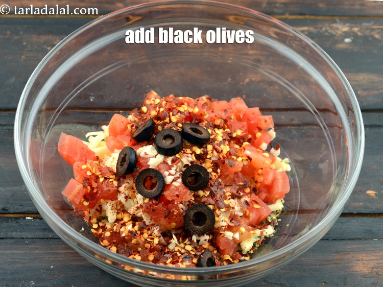 Step 9 – Add 1 1/2 tbsp&nbsp;deseeded and&nbsp;<a href="https://www.tarladalal.com/glossary-sliced-black-olives-1069i">sliced black olives</a>.&nbsp;