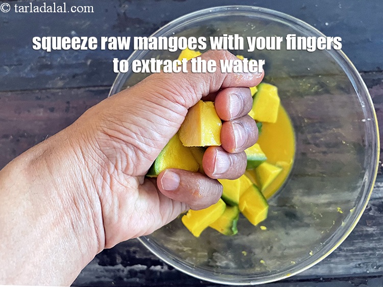 Step 17 – Squeeze the raw mangoes with your hand to extract the water.