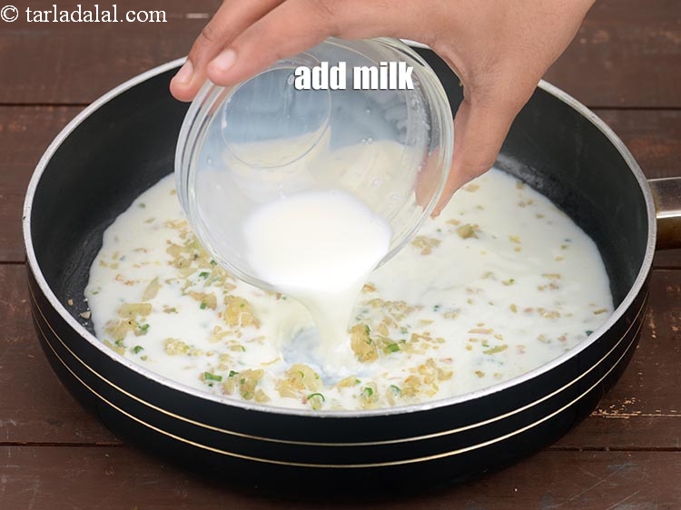 Step 9 – Add &frac12; cup <a href="https://www.tarladalal.com/glossary-milk-doodh-full-cream-milk-514i">milk</a>.