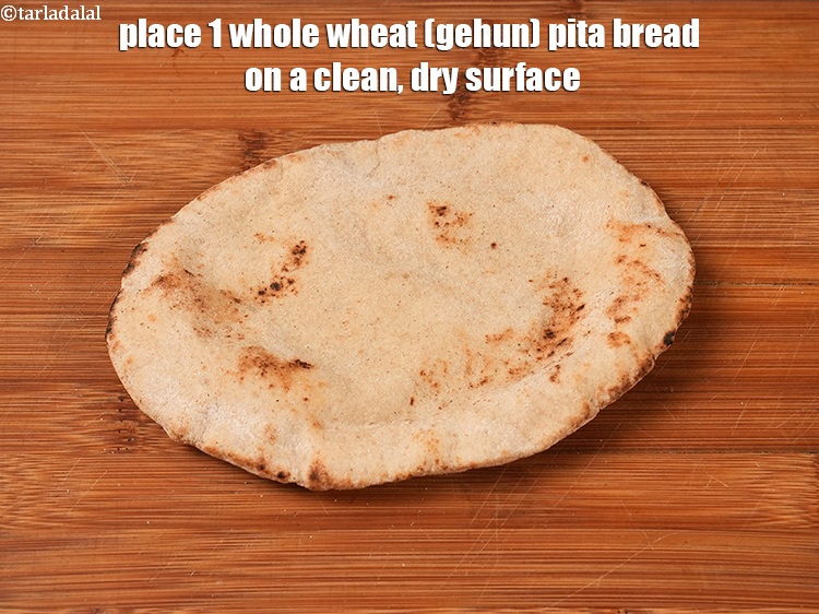 Step 30 – Place 1 whole&nbsp;<a href="https://www.tarladalal.com/glossary-wheat-whole-wheat-gehun-182i">wheat (gehun)</a>&nbsp;<a href="https://www.tarladalal.com/glossary-pita-bread-1375i">pita bread</a> on a clean, dry surface.