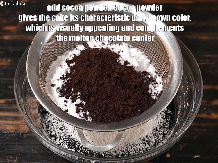 Step 10 – Add 3 tbsp <a href="https://www.tarladalal.com/glossary-cocoa-powder-284i">cocoa powder</a>. Cocoa powder gives the cake its characteristic dark brown …
