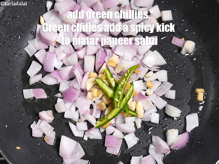 Step 10 – Add 2 slit green chillies. Green chilies add a spicy kick to matar paneer sabzi.