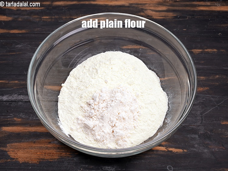 Step 11 – Add 2 tbsp <a href="https://www.tarladalal.com/glossary-plain-flour-maida-188i">plain flour (maida)</a>.