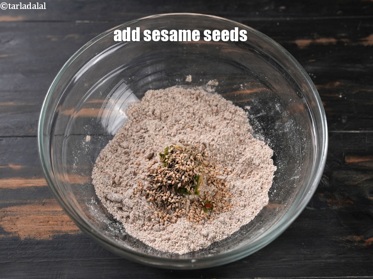 Step 10 – Add &frac12; tsp <a href="https://www.tarladalal.com/glossary-sesame-seeds-til-gingelly-seeds-612i">sesame seeds (til)</a>.