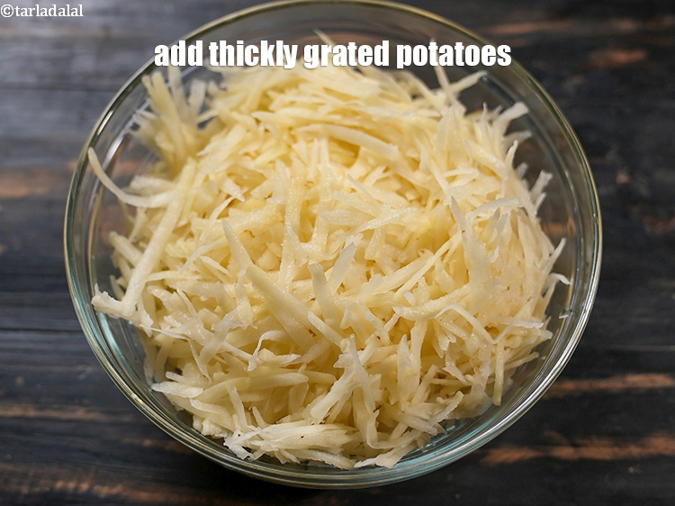 Step 10 – In a deep bowl, add 4 cups thickly&nbsp;<a href="https://www.tarladalal.com/glossary-grated-potatoes-867i">grated potatoes</a>.