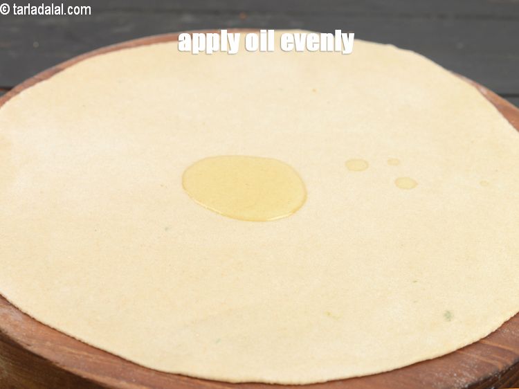 Step 10 – Apply 1/2 tbsp oil evenly over the roti.