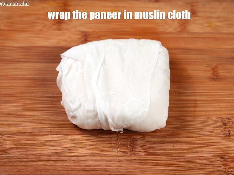 Step 10 – To make solid paneer, wrap the paneer into the muslin cloth on a clean surface.