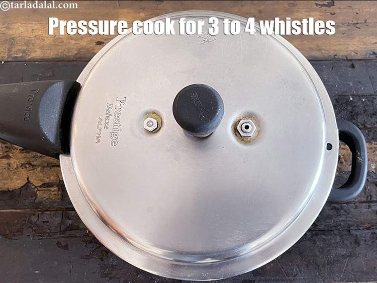 Step 29 – Pressure cook for 4 whistles.&nbsp;Allow the steam to escape before opening the lid.