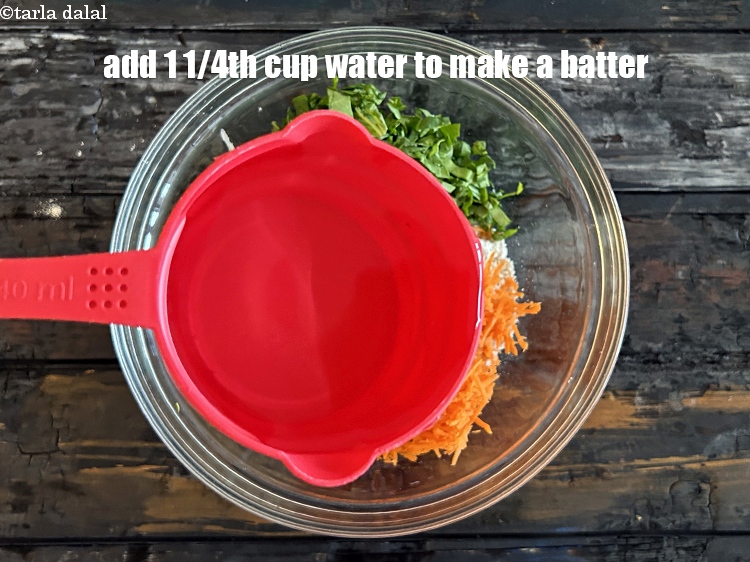 Step 10 – Add &nbsp;<strong>1 1/4th cup of water&nbsp;</strong>to make a batter.