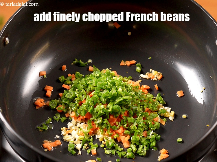 Step 14 – Add &frac14; cup finely <a href="https://www.tarladalal.com/glossary-chopped-french-beans-797i">chopped french beans</a>.