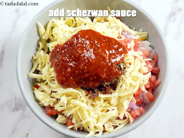 Step 11 – Add 2 tbsp <a href="https://www.tarladalal.com/glossary-schezwan-sauce-schezuan-sauce-1872i">schezwan sauce</a>.